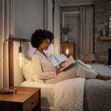 Base up cross filament LED bulb in a bedside reading lamp lighting a bedroom at night