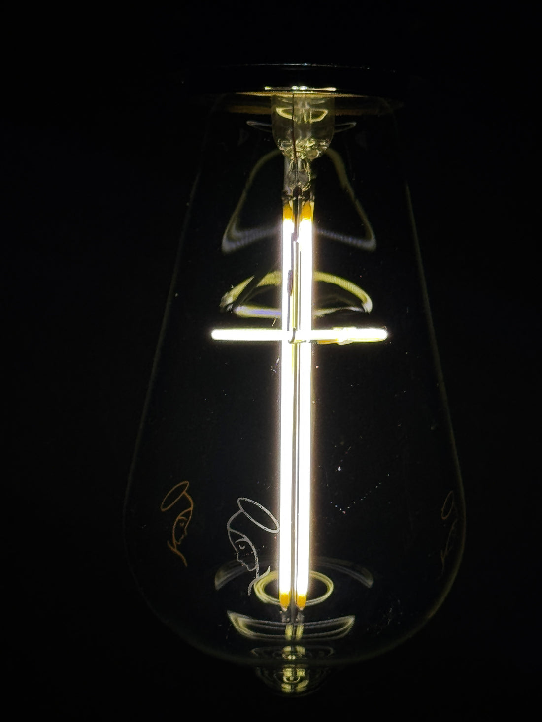 Edison-style LED bulb with an illuminated cross-shaped filament, Base Up orientation
